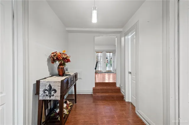 a view of a hallway to a livingroom with furniture
