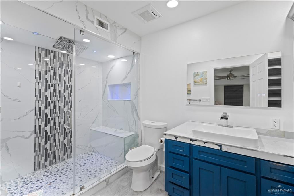 415 North 8th Street Hidalgo, TX 78557 - Photo 9 of 21 a bathroom with a sink toilet a mirror and shower