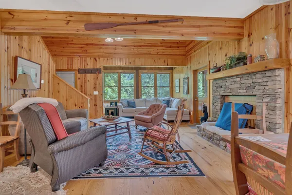 a living room with furniture a fireplace and a table
