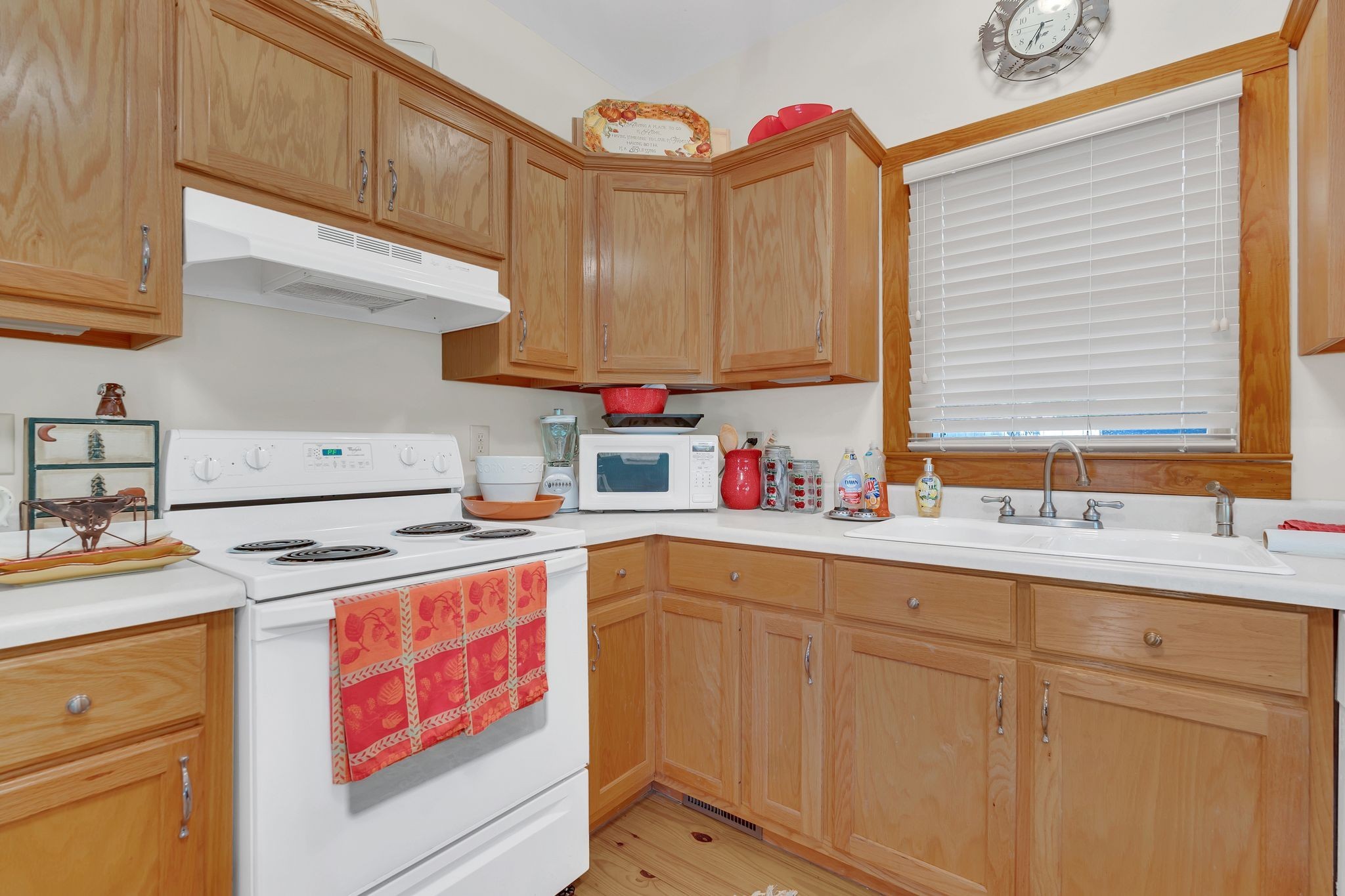 110 Village Way Lancaster, TN 38569 - Photo 13 of 27 a kitchen with granite countertop a sink stainless steel appliances wooden floor and cabinets