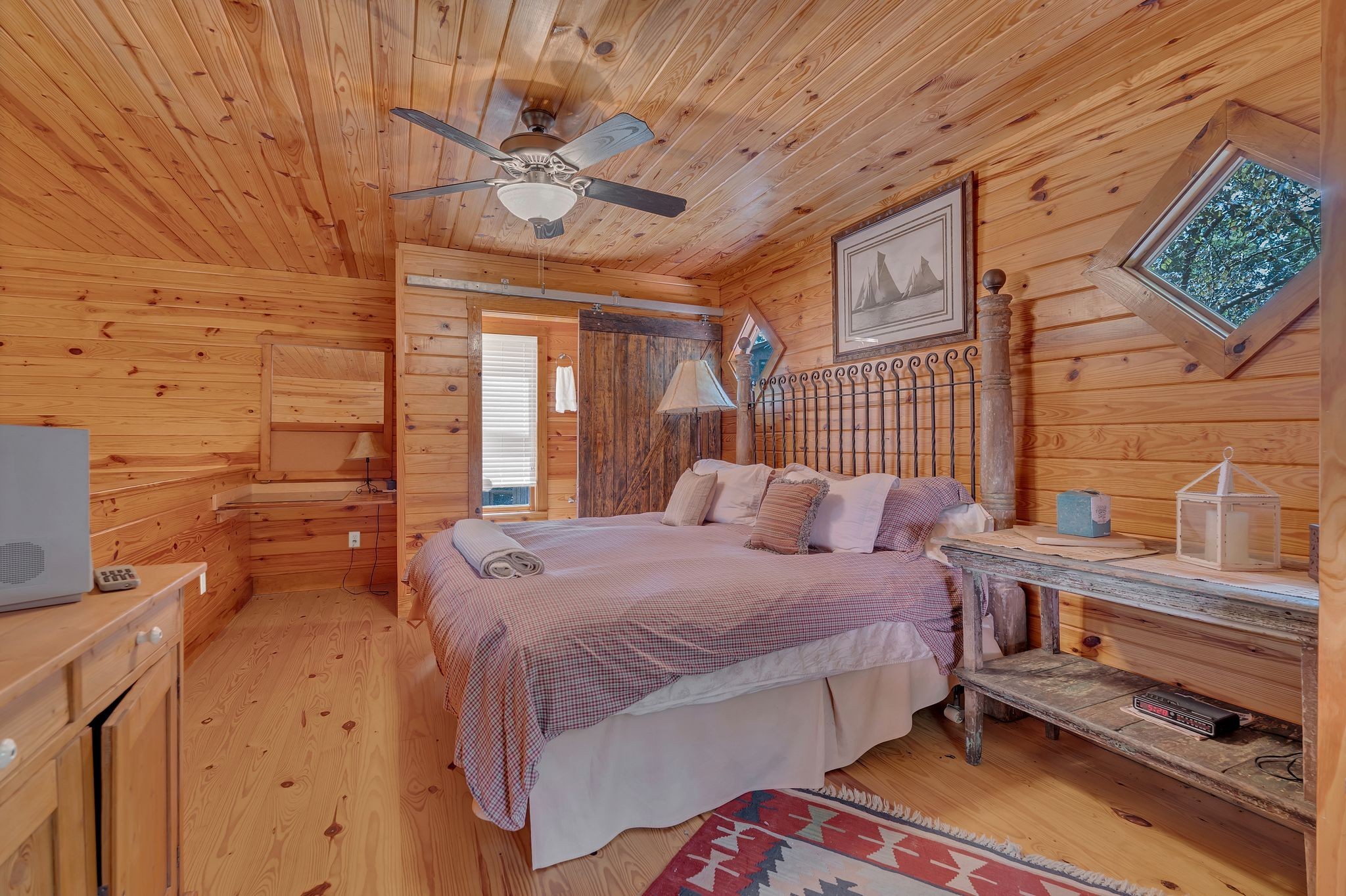 110 Village Way Lancaster, TN 38569 - Photo 21 of 27 a bedroom with a bed and a chandelier