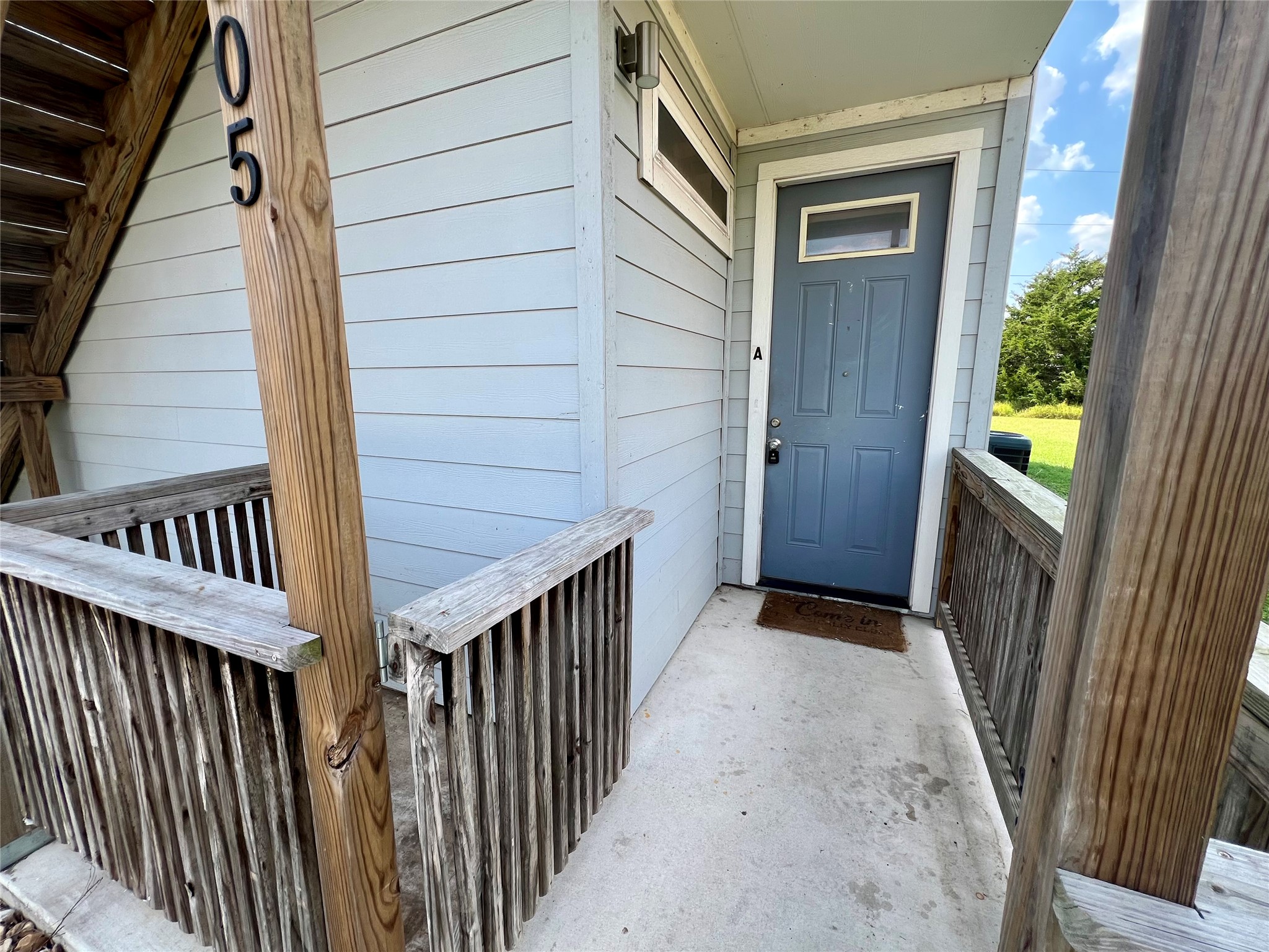 805 Hallie Cove Lockhart, TX 78644 - Photo 22 of 40 a view of a porch with wooden floor and stairs
