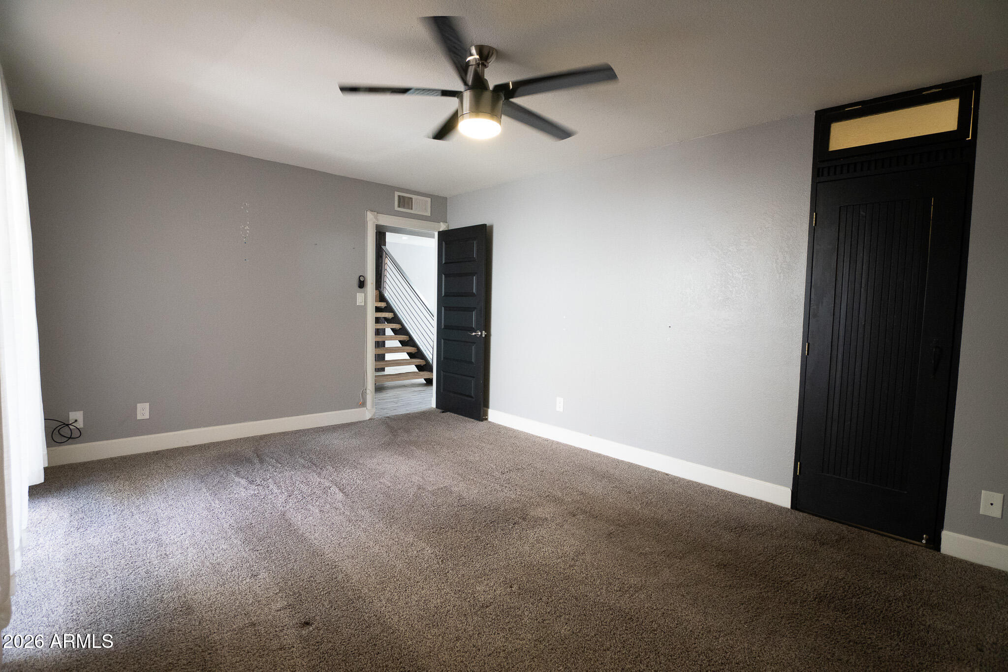 5100 North Miller Road, Unit 3 Scottsdale, AZ 85250 - Photo 23 of 31 an empty room with a ceiling fan and wooden floor
