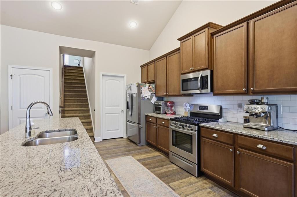 47 Violet Lane Dallas, GA 30132 - Photo 11 of 27 a kitchen with stainless steel appliances granite countertop a stove a sink dishwasher a refrigerator and a microwave