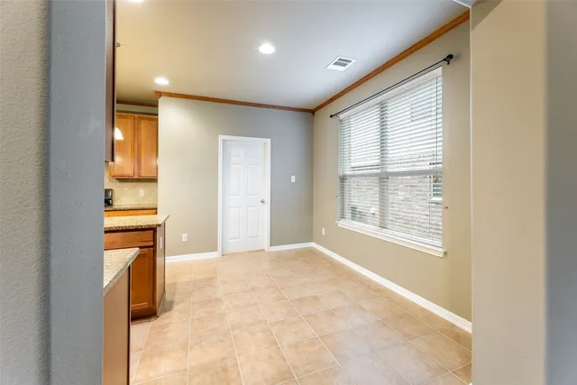 a view of an empty room with a fireplace and a window