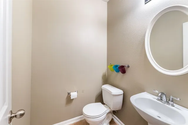 a white toilet sitting next to a bathroom sink