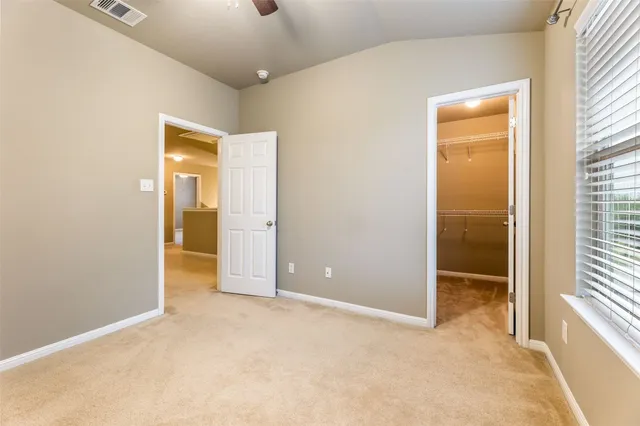 an empty room with windows and closet