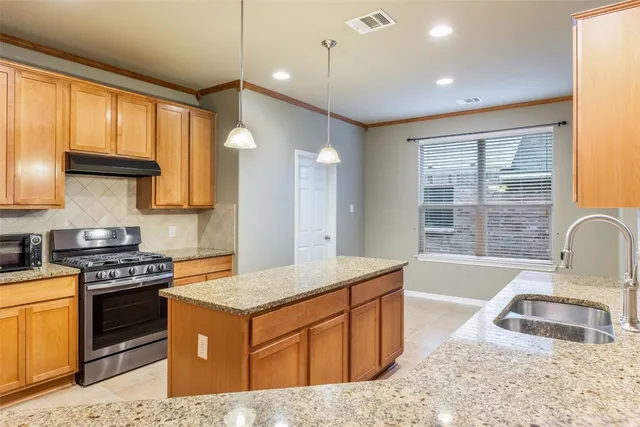 a kitchen that has a sink and a stove in it