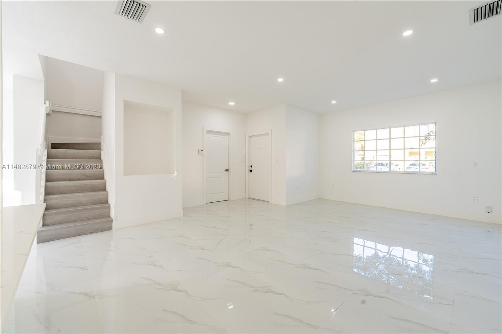 14346 Southwest 134th Place Miami, FL 33186 - Photo 14 of 36 an empty room with windows and pillars in it