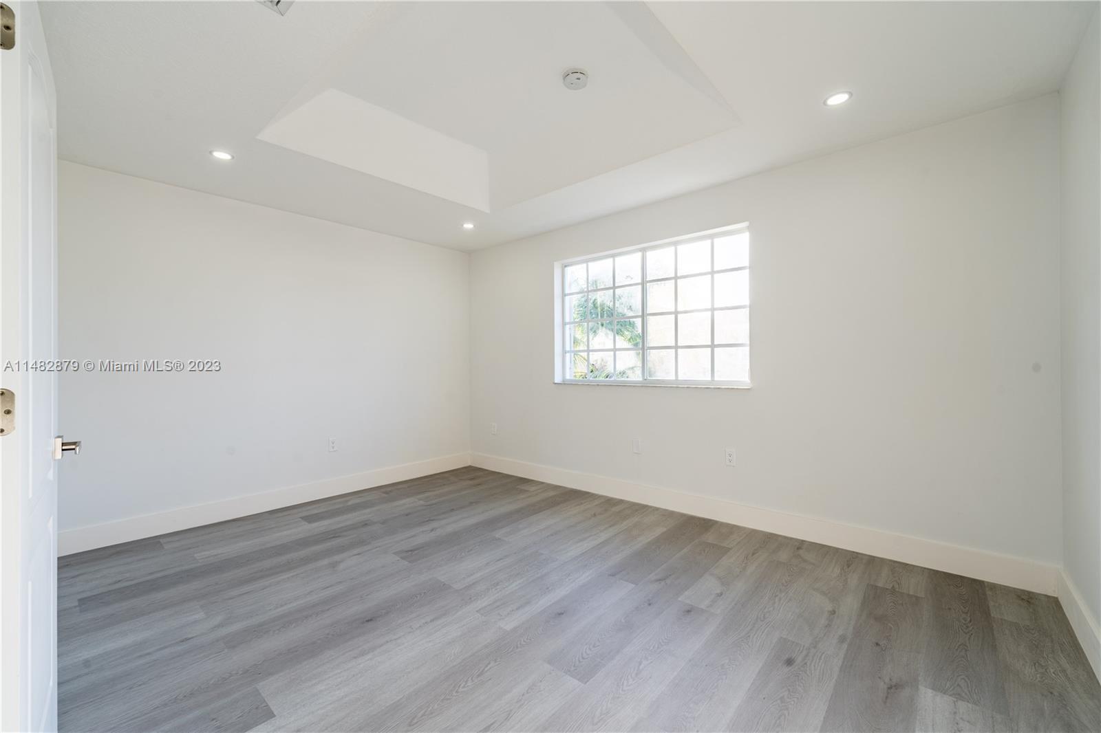 14346 Southwest 134th Place Miami, FL 33186 - Photo 20 of 36 an empty room with wooden floor and windows