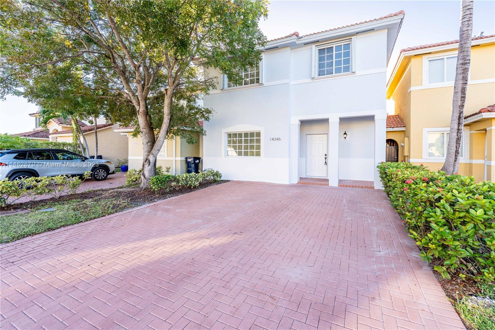 14346 Southwest 134th Place Miami, FL 33186 - Photo 2 of 36 a front view of a house with a yard and garage