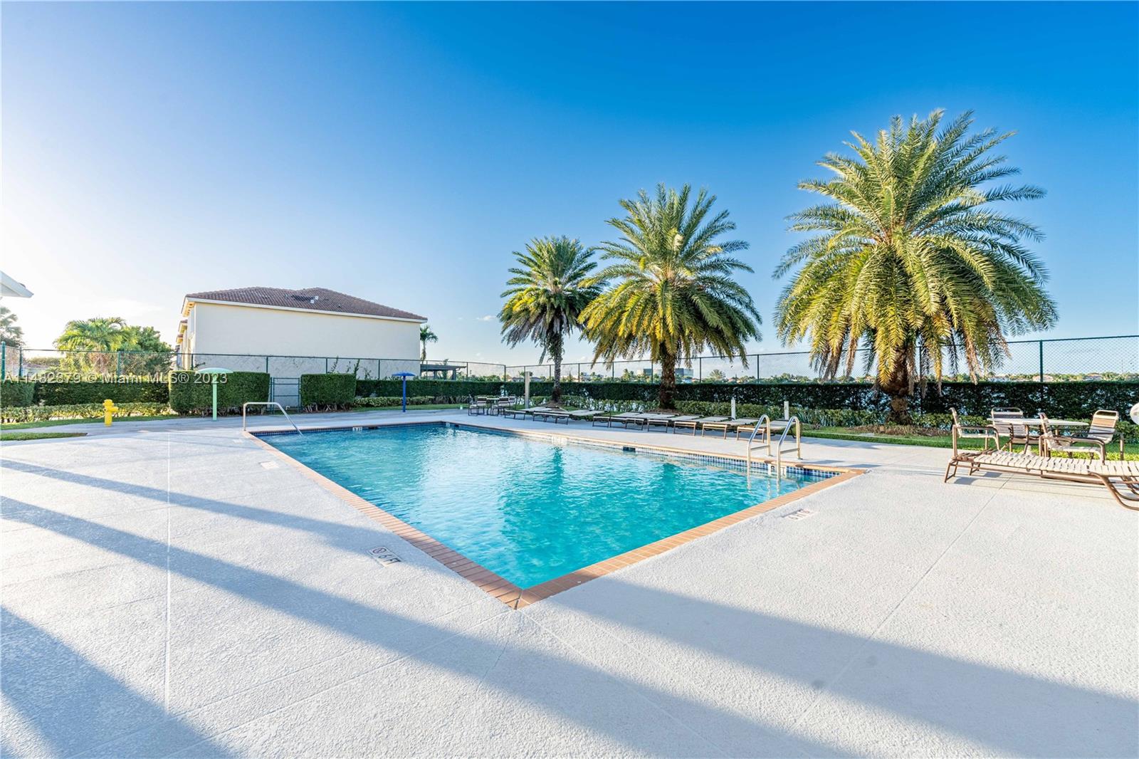 14346 Southwest 134th Place Miami, FL 33186 - Photo 33 of 36 a view of swimming pool with outdoor seating and palm tree