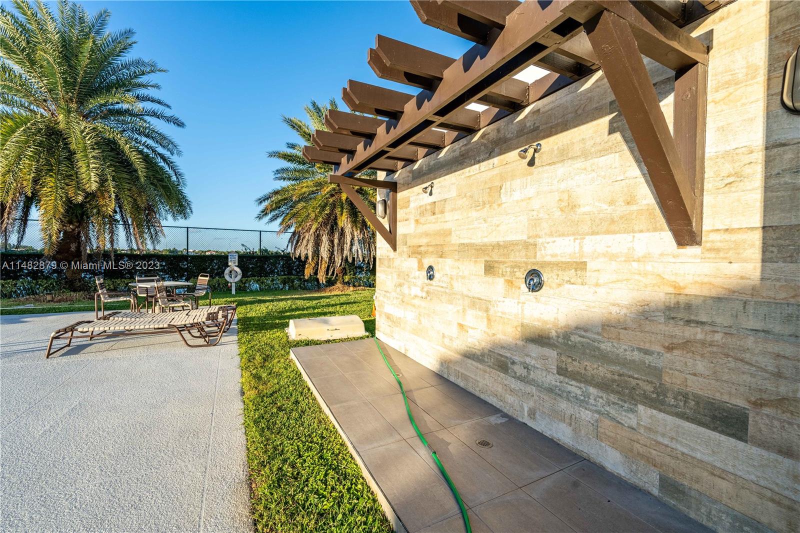 14346 Southwest 134th Place Miami, FL 33186 - Photo 36 of 36 a view of swimming pool with outdoor seating and house in the background