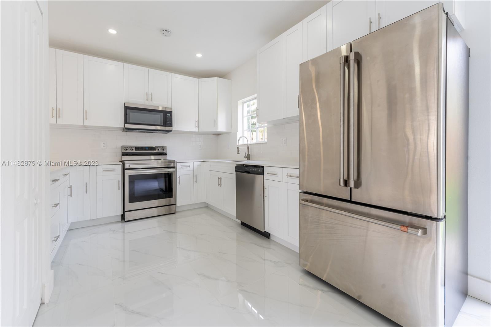 14346 Southwest 134th Place Miami, FL 33186 - Photo 9 of 36 a kitchen with stainless steel appliances a refrigerator sink and microwave