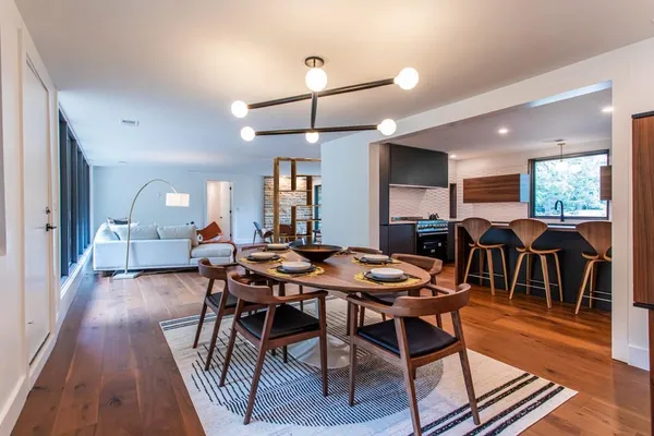a view of a dining room with furniture and wooden floor