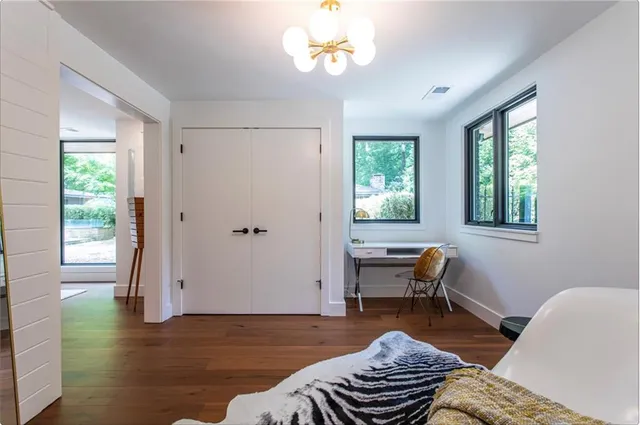 a view of a workspace with furniture and a window