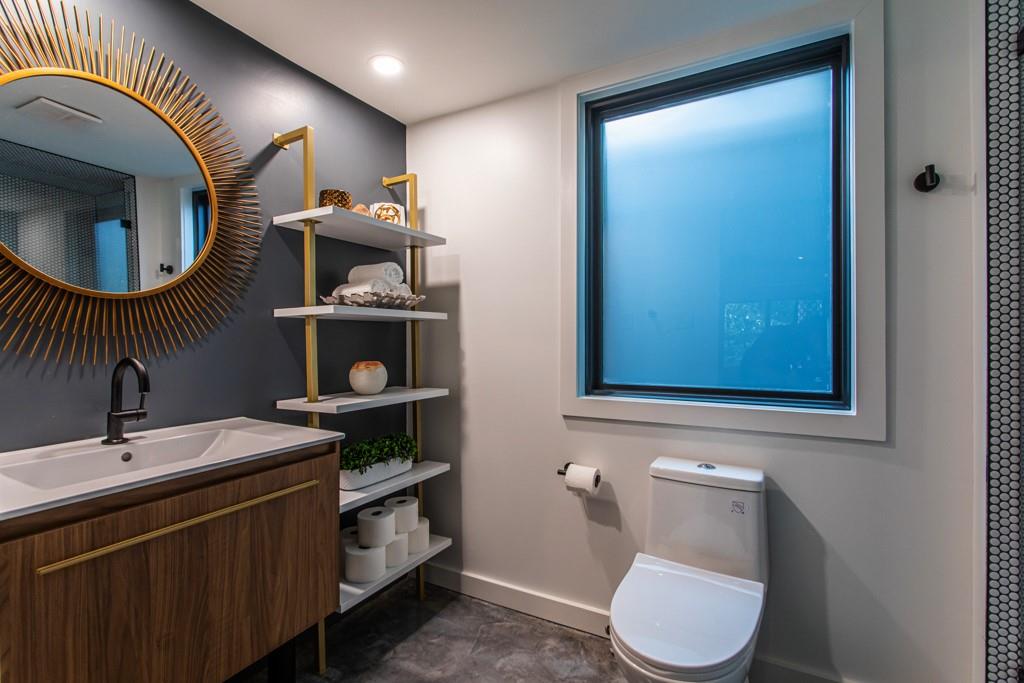 1904 Lenox Road Northeast Atlanta, GA 30306 - Photo 53 of 56 a bathroom with a toilet a sink and mirror