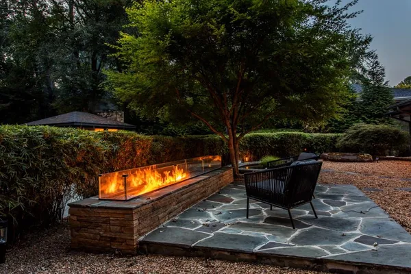 a view of a house with backyard sitting area and garden