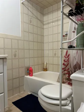 a white bath tub sitting next to a white toilet and sink