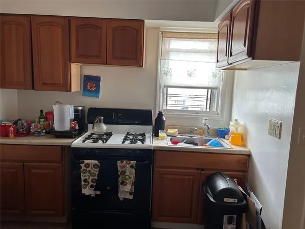 a kitchen with stainless steel appliances a sink stove and cabinets