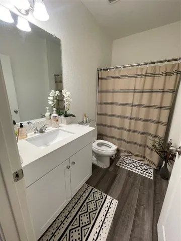 a bathroom with a sink toilet and shower
