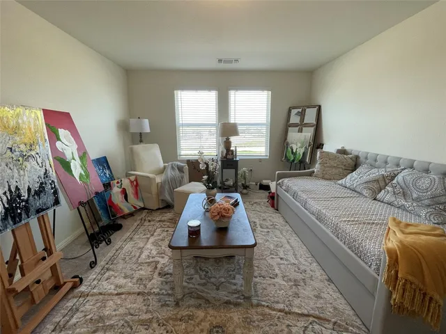a living room with furniture hard wood floor and a large window