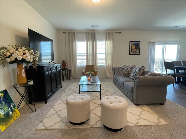 a living room with furniture and flowers