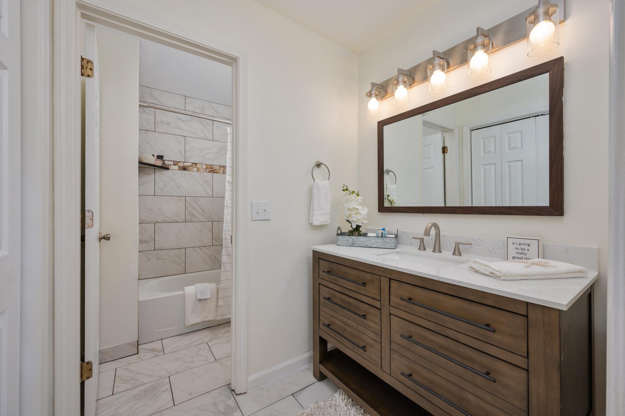 764 Kent Road Nashville, TN 37214 - Photo 13 of 20 a bathroom with a double vanity sink mirror and shower