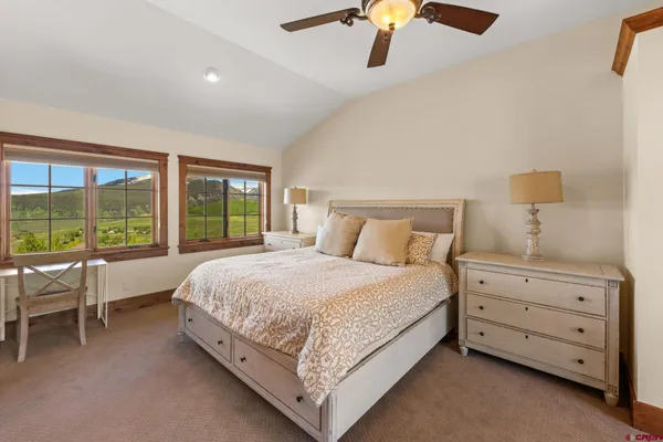 a bed room with a bed and a chair