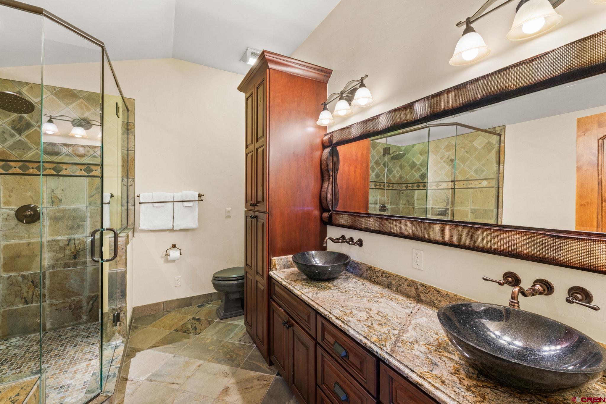 59 Summit Road Crested Butte, CO 81225 - Photo 21 of 45 a bathroom with a granite countertop sink a toilet and shower
