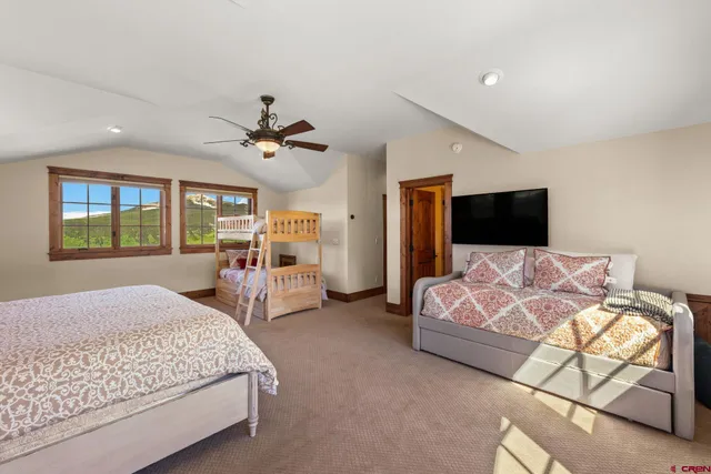 a bedroom with bed tv and window