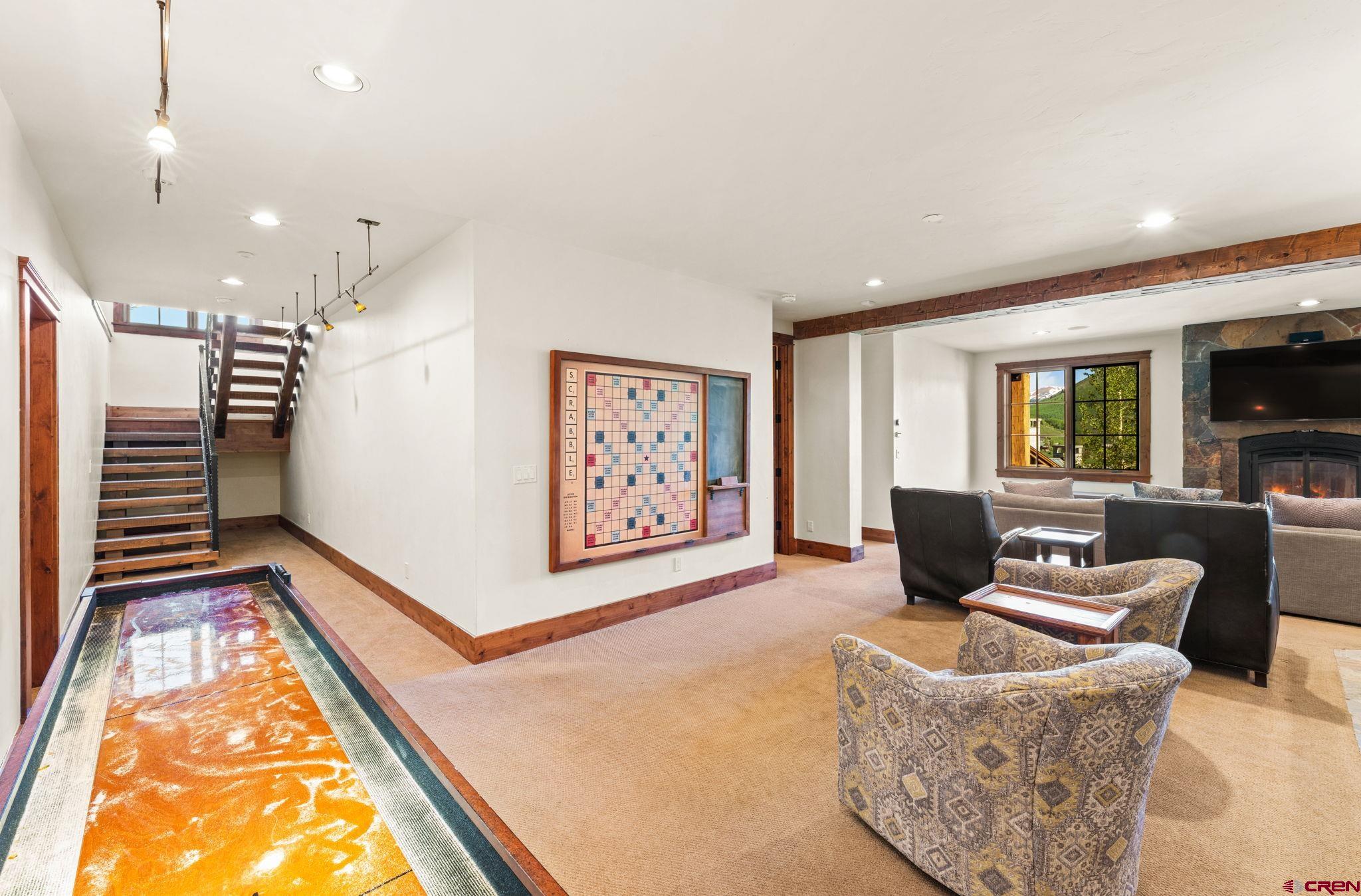 59 Summit Road Crested Butte, CO 81225 - Photo 27 of 45 a living room with furniture a flat screen tv and a fireplace