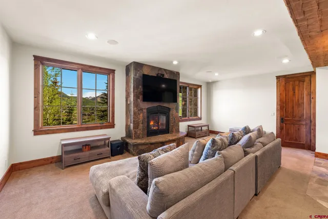 a living room with furniture a fireplace and a flat screen tv
