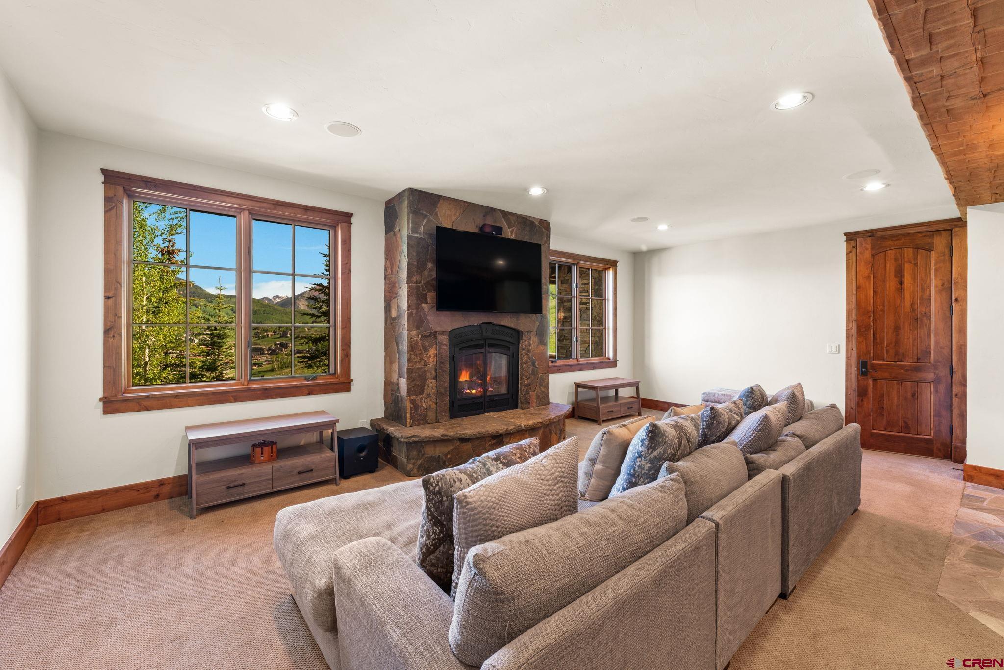59 Summit Road Crested Butte, CO 81225 - Photo 30 of 45 a living room with furniture a fireplace and a flat screen tv