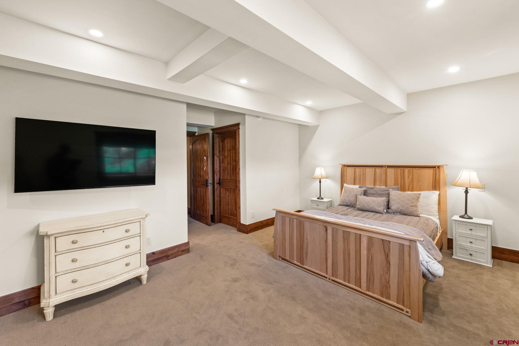 59 Summit Road Crested Butte, CO 81225 - Photo 35 of 45 a bedroom with furniture and a flat screen tv