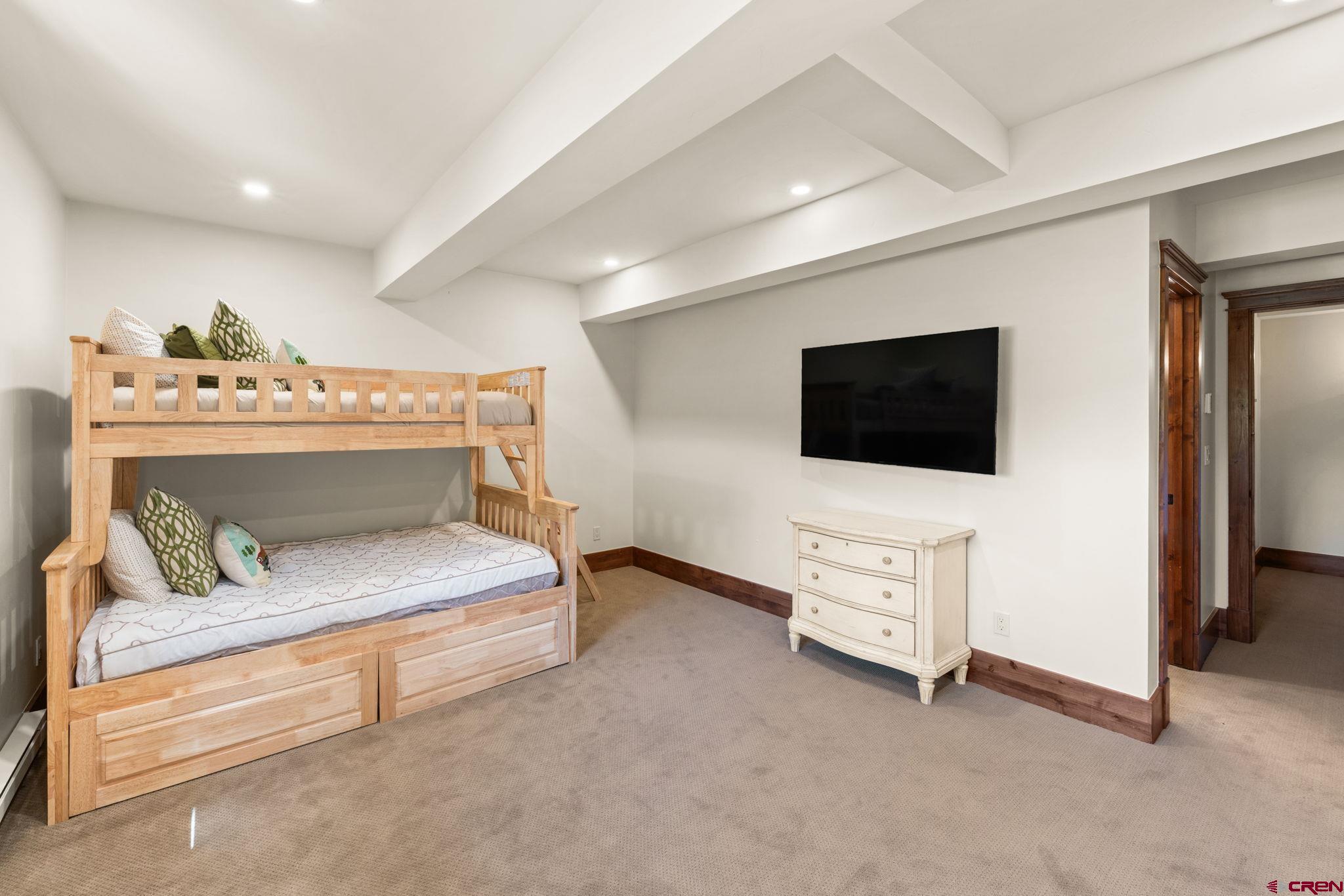 59 Summit Road Crested Butte, CO 81225 - Photo 36 of 45 a bedroom with furniture and flat screen tv