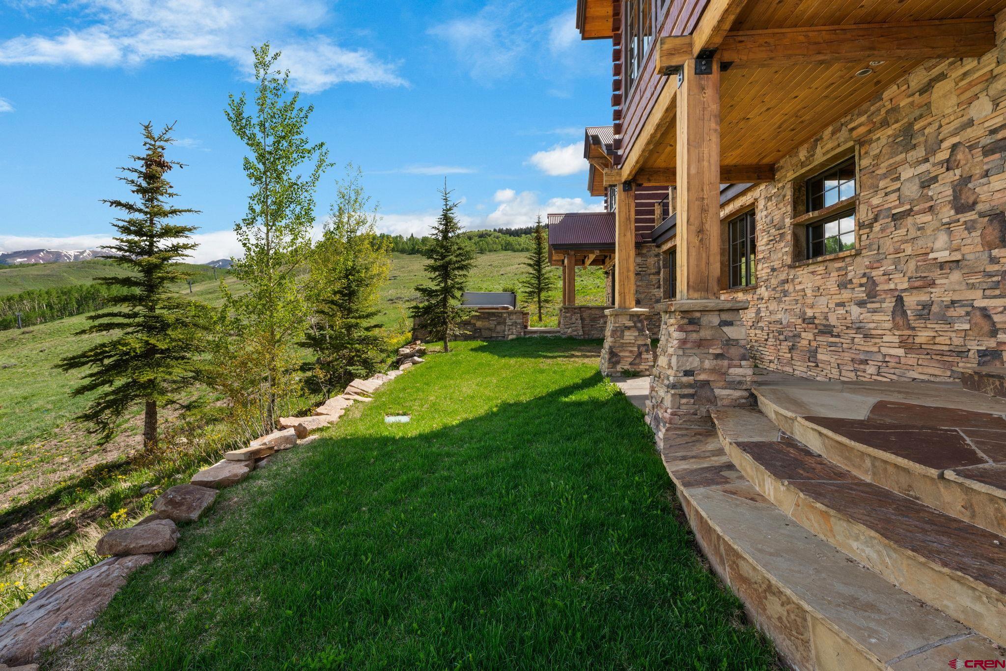 59 Summit Road Crested Butte, CO 81225 - Photo 44 of 45 a backyard of a house with lots of green space