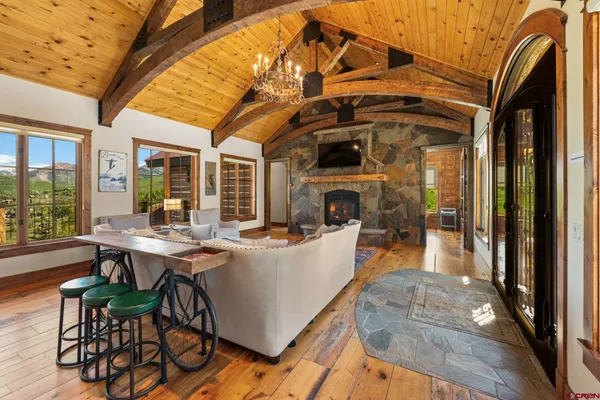 a dining room with furniture and wooden floor
