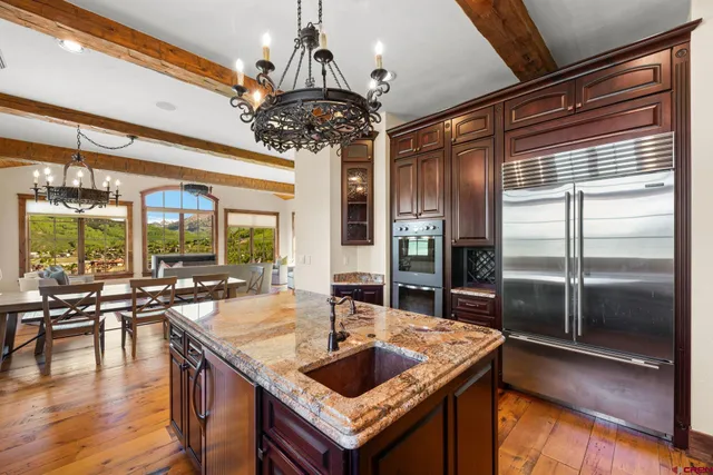 a kitchen with a table chairs and chandelier