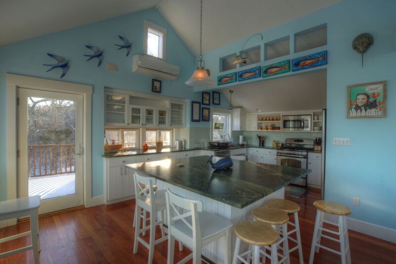 72 Chappaquiddick Road Edgartown, MA 02539 - Photo 5 of 13 a kitchen with stainless steel appliances granite countertop a sink dishwasher and cabinets with wooden floor