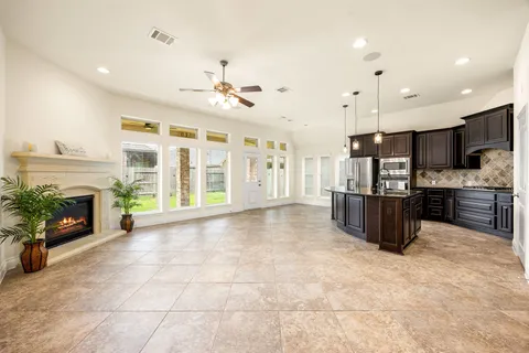 a large kitchen with a large window and stainless steel appliances