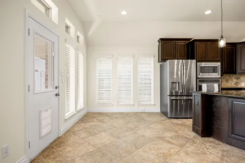 a view of a kitchen with a sink and a refrigerator