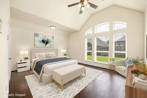 a spacious bedroom with a bed and a large window