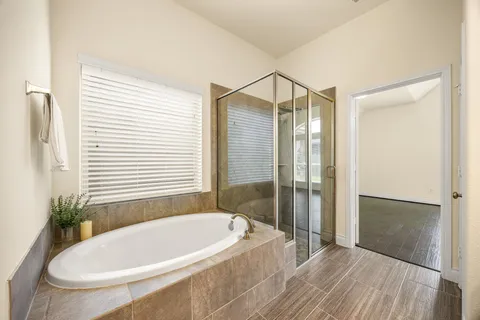 a bathroom with a tub and shower