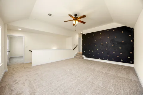 a view of an empty room with a ceiling fan