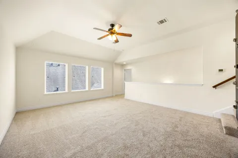 a view of a livingroom with a ceiling fan and window