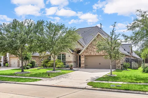 a front view of a house with a yard and a garage