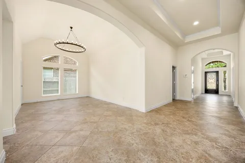 a view of a room with windows and entryway