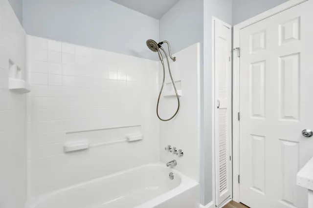 a bathroom with a granite countertop sink a toilet and shower