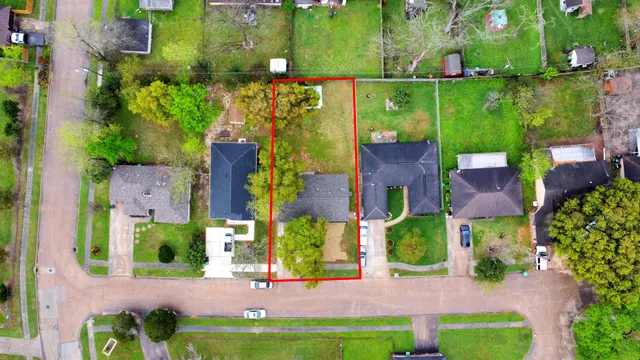 a front view of a house with a garden and yard